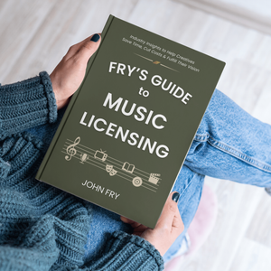 Book titled 'Fry's Guide to Music Licensing' held by a person with a neutral background