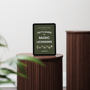 Tablet displaying 'Fry's Guide to Music Licensing' on a wooden stand with a plant in the foreground.